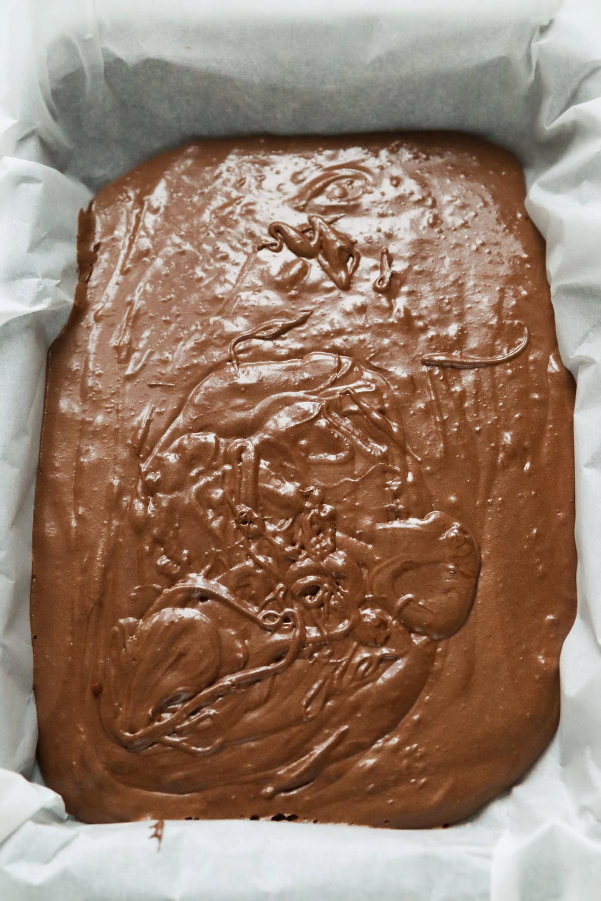 orange brownie batter in tray