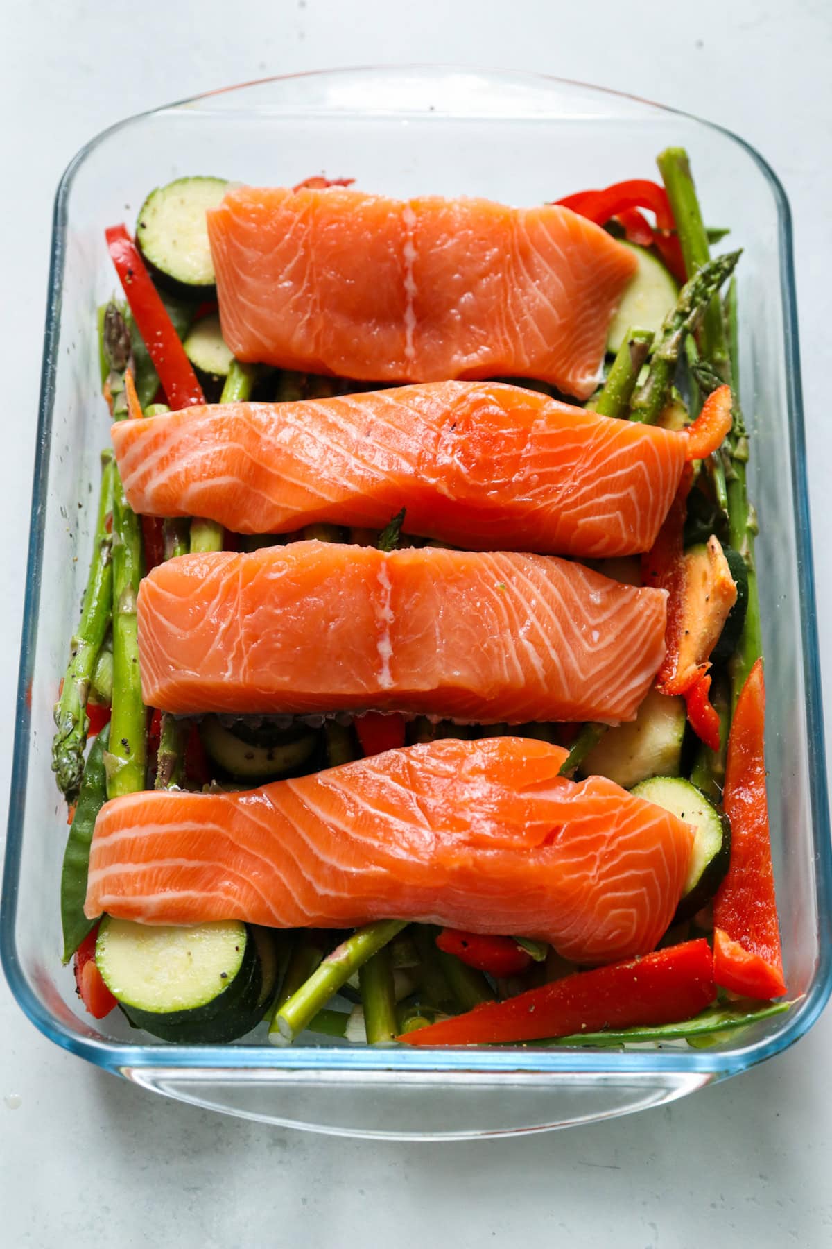 Salmon laid on top of vegetables.