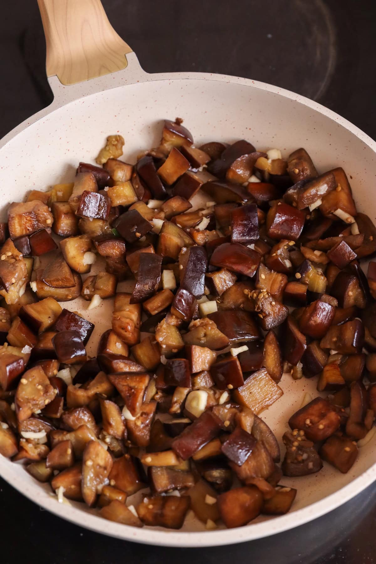 Garlic added to aubergine.